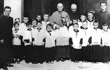 Anni Quaranta: Visita pastorale, un gruppo di chierichetti con il Card. Elia della Costa, il preposto don D. Galeotti e il cappellano don Bruno Poli (a sin.)